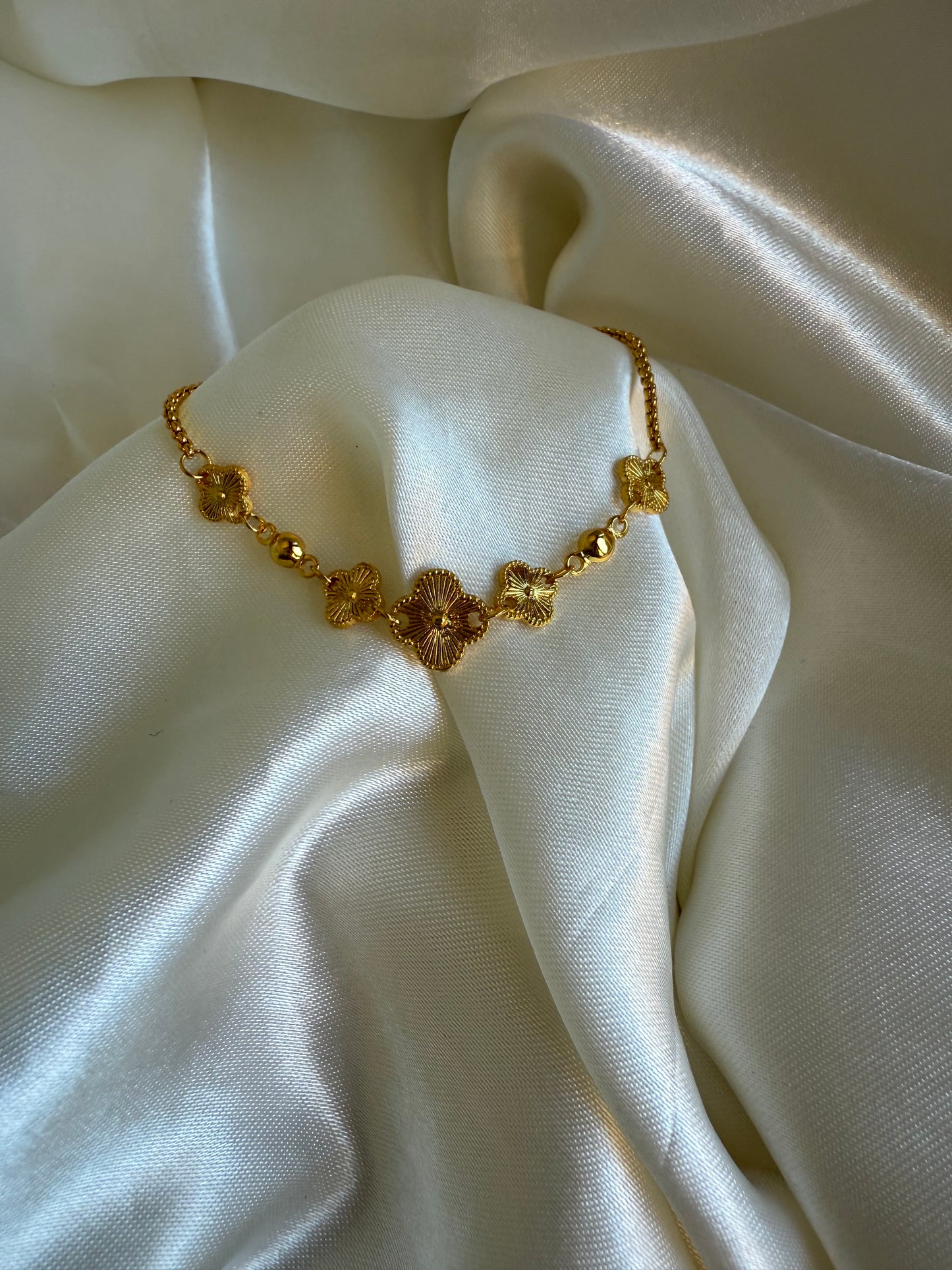 Gold clover charm bracelet, textured floral clover design from Asiatic Moon